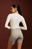 Back view of the white fitted full sleeve gym top during a workout