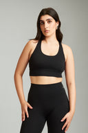 Black OnTheGo cross back sports bra designed for comfort, support, and movement