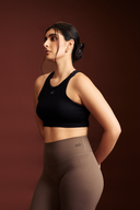 Black cropped tank top with a fitted design for women's activewear