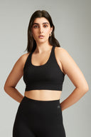 Black strappy sports bra for women suitable for yoga, training, and gym workouts