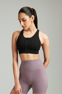 Black zip up sports bra featuring a secure front zipper closure and supportive fit