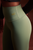 Close-up of forest green OnTheGo leggings waistband, soft polyester-free fabric that stays in place during workouts