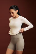 Front view of a white full sleeve gym top for women's activewear