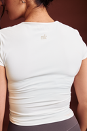 White baby tee featuring a fitted design for effortless everyday styling