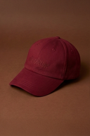 Woman wearing a maroon gym cap with activewear