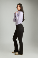 Women wearing Black OnTheGo flare yoga pants with a flattering high-rise fit