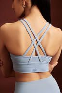 Women wearing Frost cross back sports bra with breathable stretch fabric and a secure fit