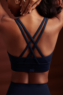 Women wearing Ink Blue cross back bra with breathable stretch fabric and a secure fit