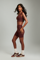 Women wearing Maroon OnTheGo athletic shorts with a supportive and flattering fit