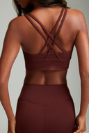 Women wearing Maroon cross back sports bra with breathable stretch fabric and a secure fit