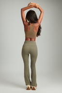 Women wearing Olive OnTheGo flare yoga pants with a flattering high-rise fit