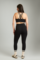 Women wearing black workout leggings during yoga, squat-proof 4-way stretch fabric